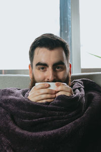 Portrait of man drinking coffee