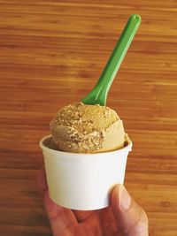 Close-up of hand holding ice cream