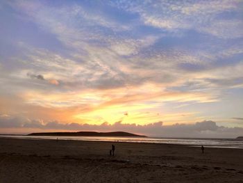 Scenic view of beach against sky during sunset