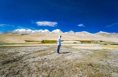 Full length of man standing on land against sky
