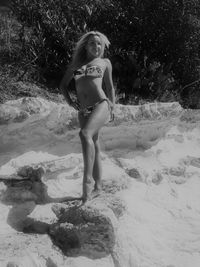 Portrait of young woman standing on land