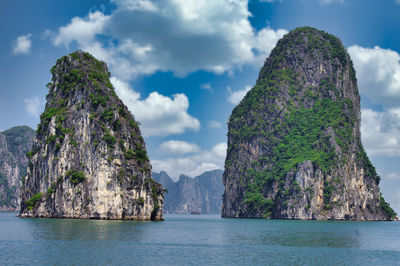 Rock formations in sea against sky