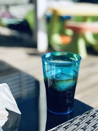 Close-up of coca cola on table