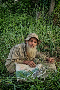 Portrait of man sitting in field