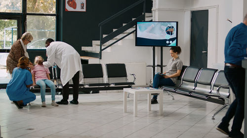 Rear view of people working at airport