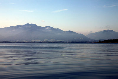 Scenic view of sea and mountains against sky