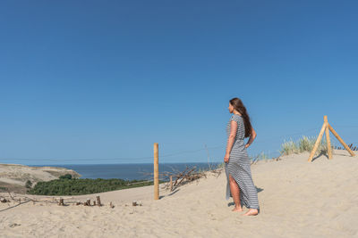 Full length of woman standing on beach