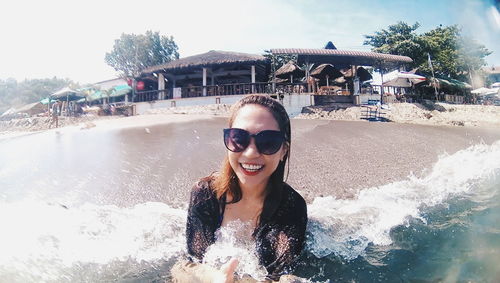 Portrait of smiling young woman in swimming pool