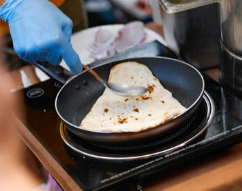 Cropped hand of person preparing food