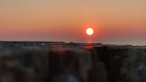 Close-up of sea against sky during sunset