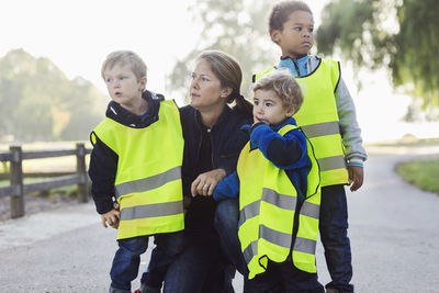 Teacher and children looking away at playground