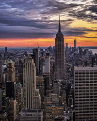 Aerial view of buildings in city during sunset