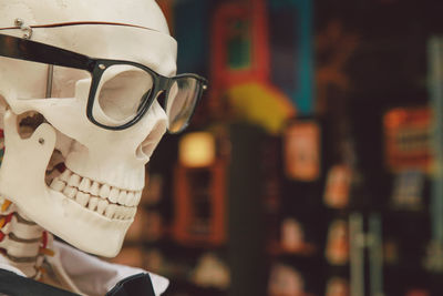 Close-up of eyeglasses on skeleton statue