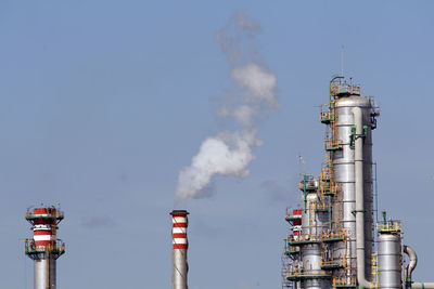 Low angle view of smoke stack against sky