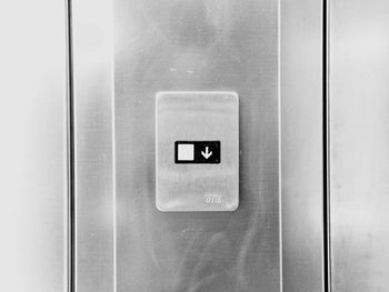 Close-up of arrow sign in elevator