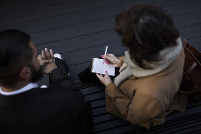 Colleagues sitting on bench and planning