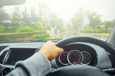 Midsection of man driving car