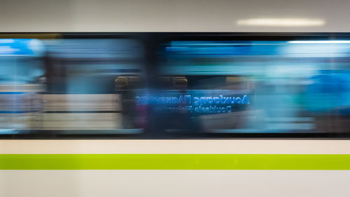 Blurred motion of train at railroad station