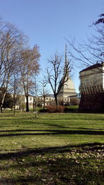 Built structure on grassy field against blue sky