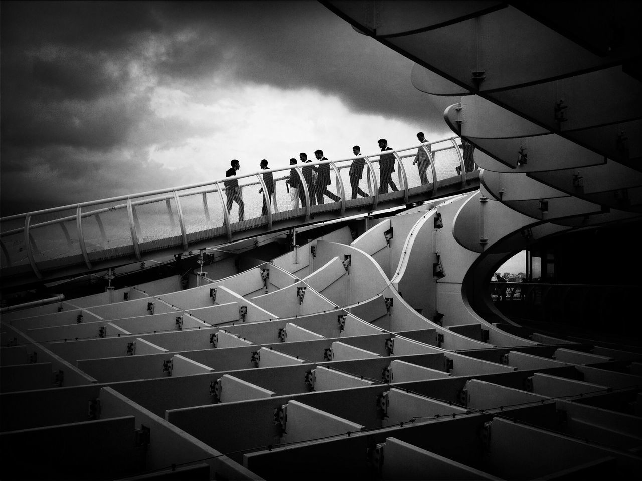 sky, cloud - sky, railing, built structure, architecture, cloudy, water, pattern, walking, silhouette, men, incidental people, cloud, leisure activity, person, bridge - man made structure, lifestyles, outdoors, day