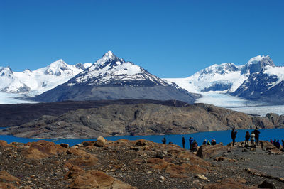 Scenic view of snowcapped mountains against clear blue sky