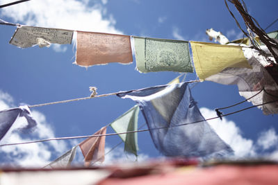 Low angle view of flags hanging against sky