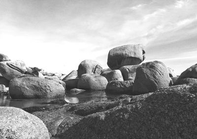 Rocks on field against sky