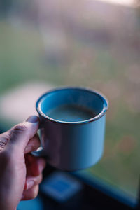 Close-up of hand holding coffee cup