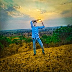 Full length of man standing on field against sky