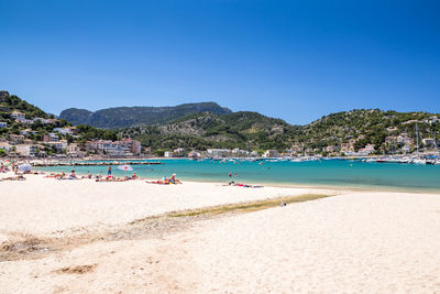 Scenic view of beach against clear blue sky