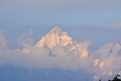Low angle view of snowcapped mountain against sky