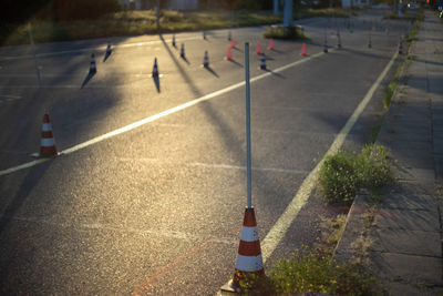 High angle view of arrow symbol and cones on road in city driving school