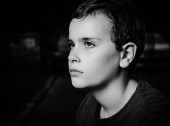 Close-up portrait of teenage boy looking away