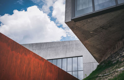 Low angle view of building against cloudy sky