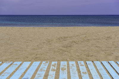 Wooden planks on sand at beach