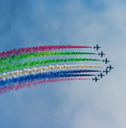 Low angle view of airshow against sky