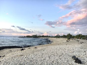 Scenic view of beach against sky during sunset