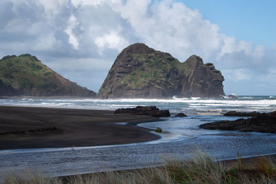 Scenic view of sea and mountains against sky