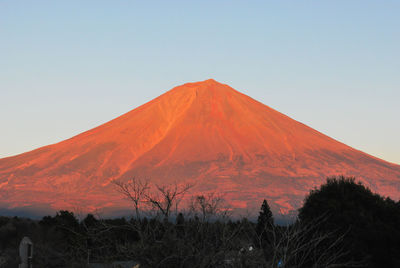 Scenic view of mountains against clear sky during sunset