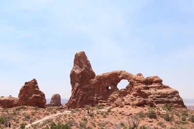 Low angle view of rock formations at arches national park against sky