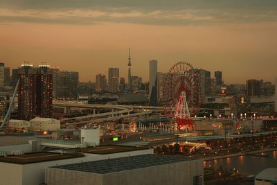 Illuminated cityscape against sky