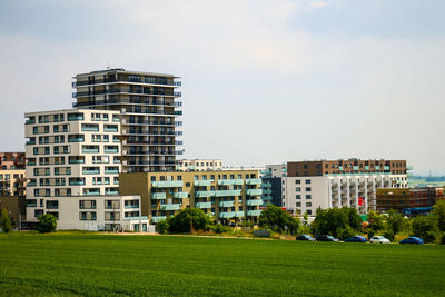 Buildings in city against clear sky