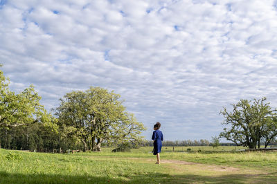 Woman walking outdoors in the field.