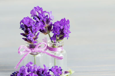 Close-up of purple flower vase on table