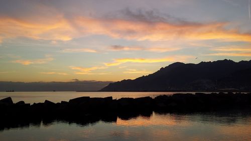 Scenic view of lake against romantic sky at sunset