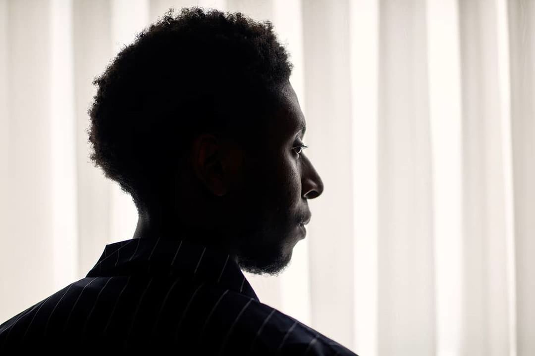 headshot, portrait, one person, young adult, indoors, young men, real people, beard, lifestyles, facial hair, looking, side view, looking away, close-up, men, leisure activity, home interior, contemplation, hairstyle, profile view