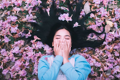 Directly above shot of woman lying on field