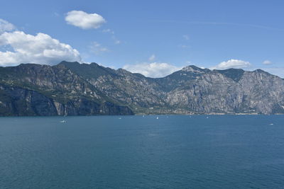 Scenic view of sea and mountains against sky