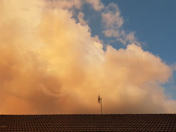 Low angle view of houses against sky during sunset