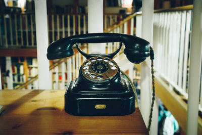 Close-up of old telephone on table